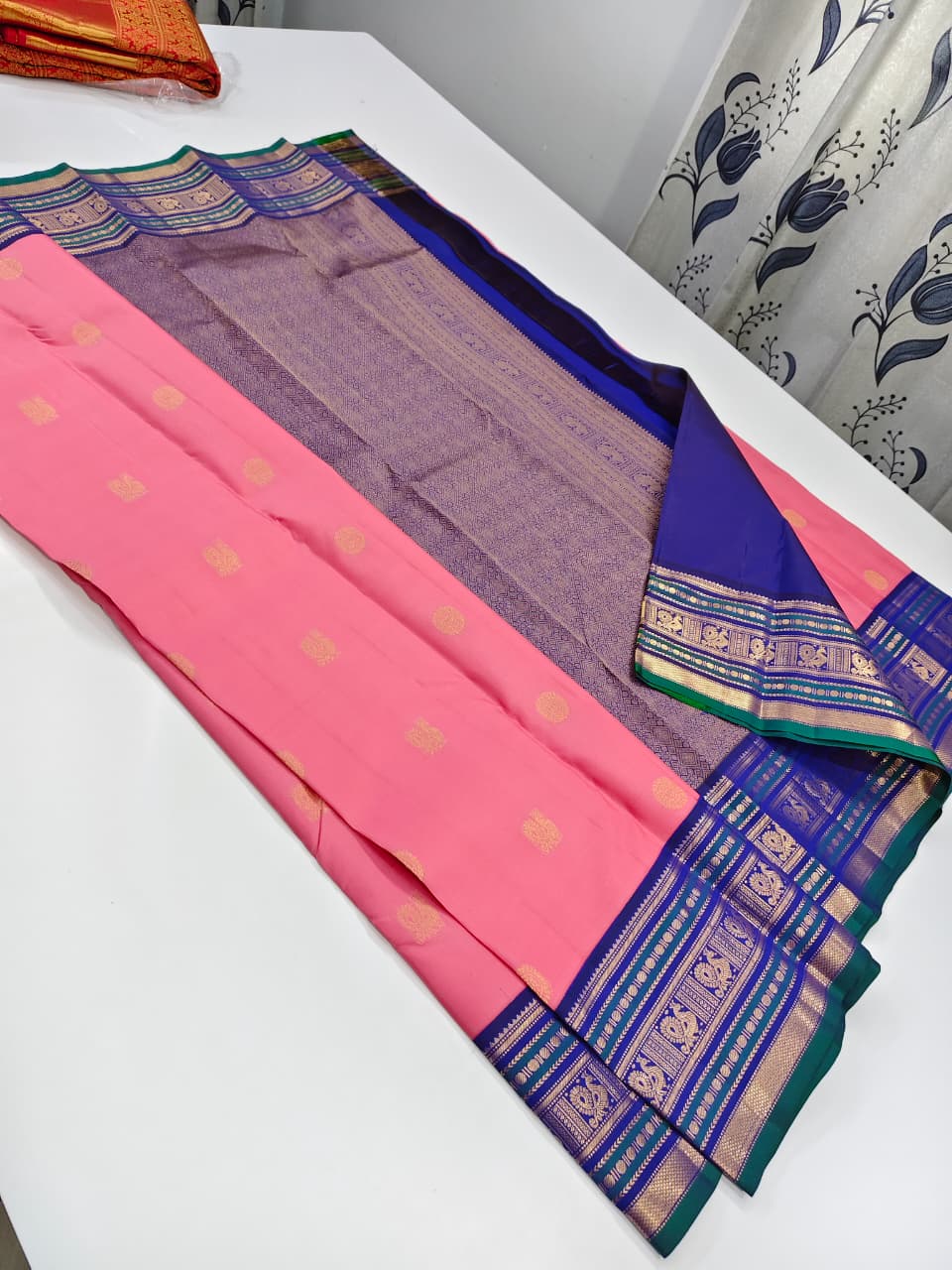Handloom Kanchipuram Silk Saree with a traditional contrast border and buttas.